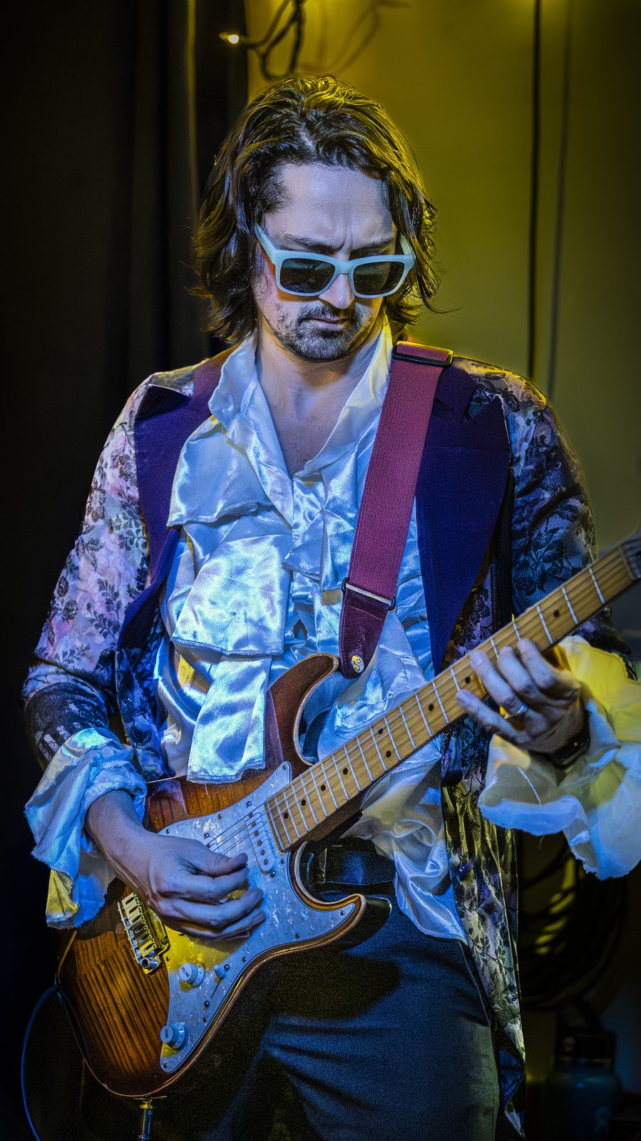 Mike Lurincic playing his Stratocaster, ruffled shirt