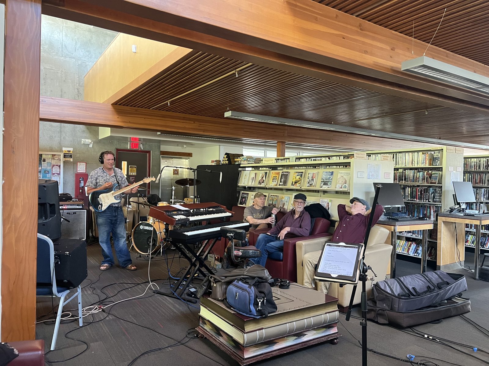 Mike playing guitar with the crew watching