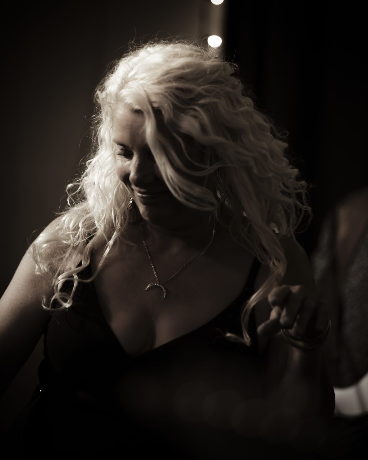 Sarah Dawn Morris in black and white, curls falling forward