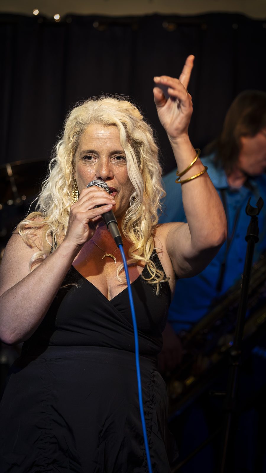 Sarah Dawn Morris singing with hand raised