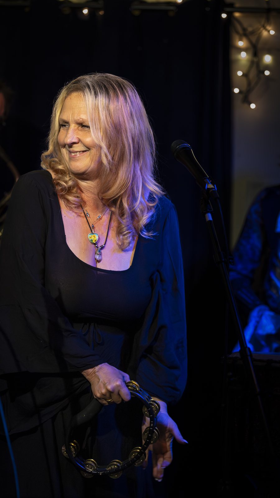 Tonya Horoky Cooper with tambourine, smiling